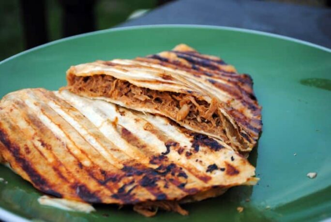 Slow cooker pulled pork is one of the easiest and most delicious dinner recipes you will ever make. It's spiced with a rich BBQ flavor and is great on sandwiches, in wraps, and even on salads.