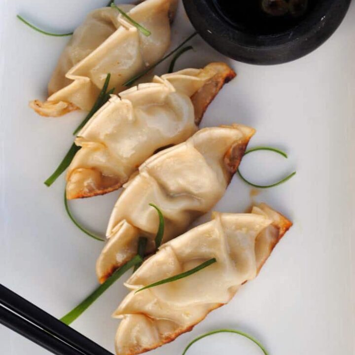 Asian pot stickers are delicious Asian dumplings filled with spinach, green onions, ginger, and pork. They're a tasty appetizer, or serve them with a side salad for a light meal. \\ Get the recipe on PassTheSushi.com
