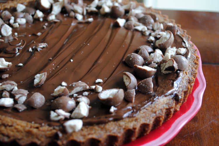 Malted milk cookie tart. A buttery, malted milk cookie crust topped with chocolate and malted milk balls. The dessert of champions! Get the recipe on passthesushi.com