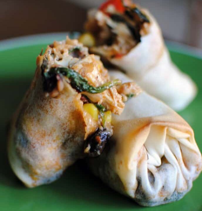Southwest-style eggrolls are packed with chicken, corn, spinach, and southwest spices. Serve them with a spicy chipotle cream dip for a delicious appetizer or game day snack food. | Get the recipe from PassTheSushi.com