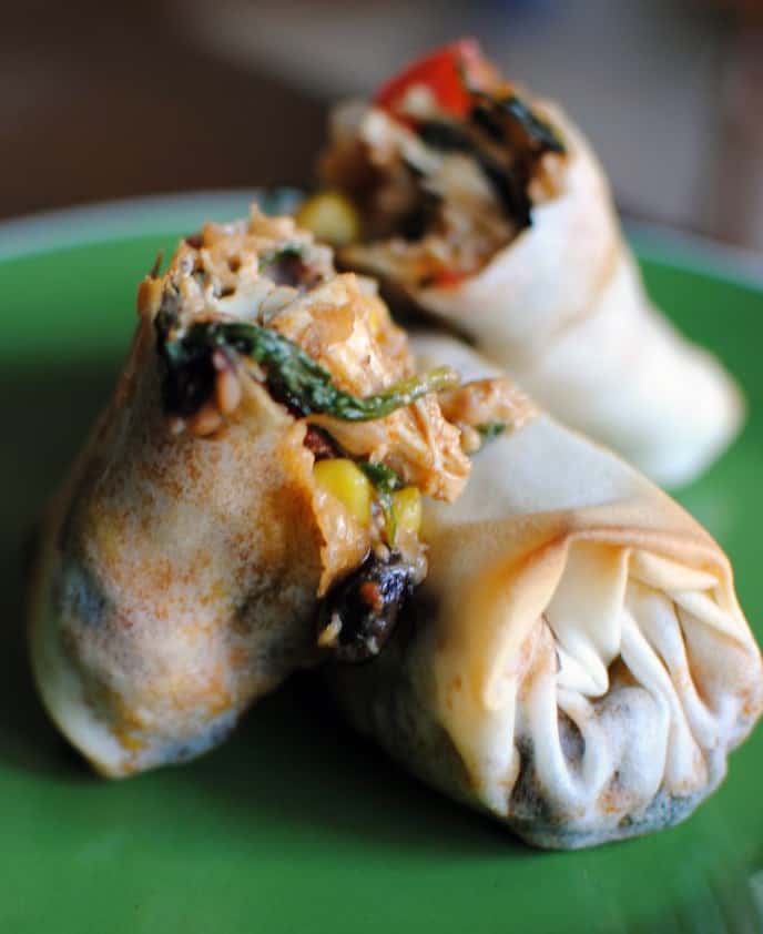 Southwest-style eggrolls are packed with chicken, corn, spinach, and southwest spices. Serve them with a spicy chipotle cream dip for a delicious appetizer or game day snack food. | Get the recipe from PassTheSushi.com