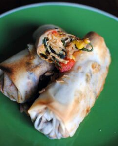 Southwest-style eggrolls are packed with chicken, corn, spinach, and southwest spices. Serve them with a spicy chipotle cream dip for a delicious appetizer or game day snack food. | Get the recipe from PassTheSushi.com