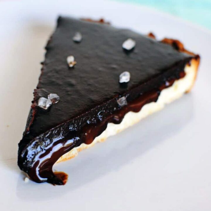 Salted caramel chocolate tart tastes amazingly like a Twix candy bar. Salted caramel and chocolate inside of a tender shortbread crust. Get the dessert recipe from PassTheSushi.com