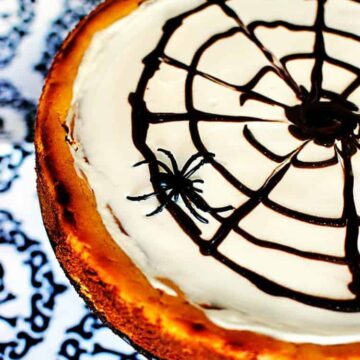 This Halloween pumpkin cheesecake is a rich, creamy pumpkin flavored cheesecake, decorated to look like a spider web. So fun to make! \\ See the recipe on PassTheSushi.com