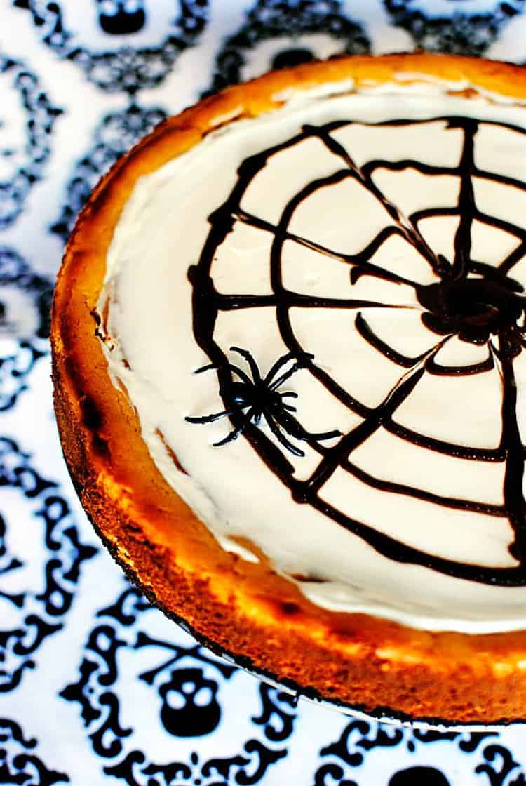 This Halloween pumpkin cheesecake is a rich, creamy pumpkin flavored cheesecake, decorated to look like a spider web. So fun to make! \\ See the recipe on PassTheSushi.com