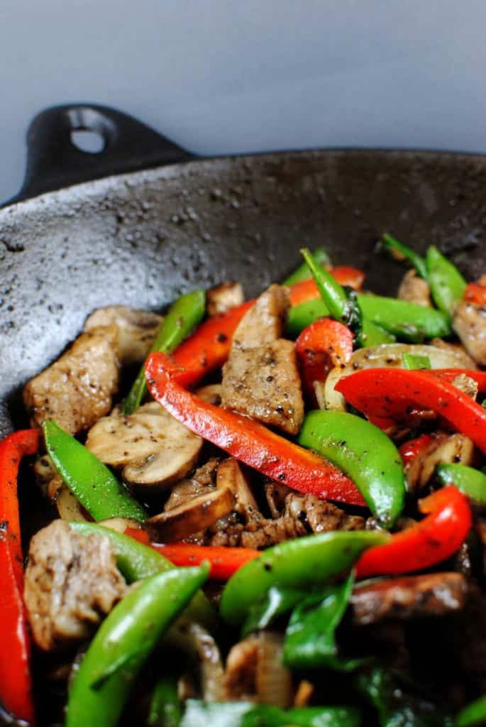 Black Pepper Pork Stir Fry in a wok \ PassTheSushi.com