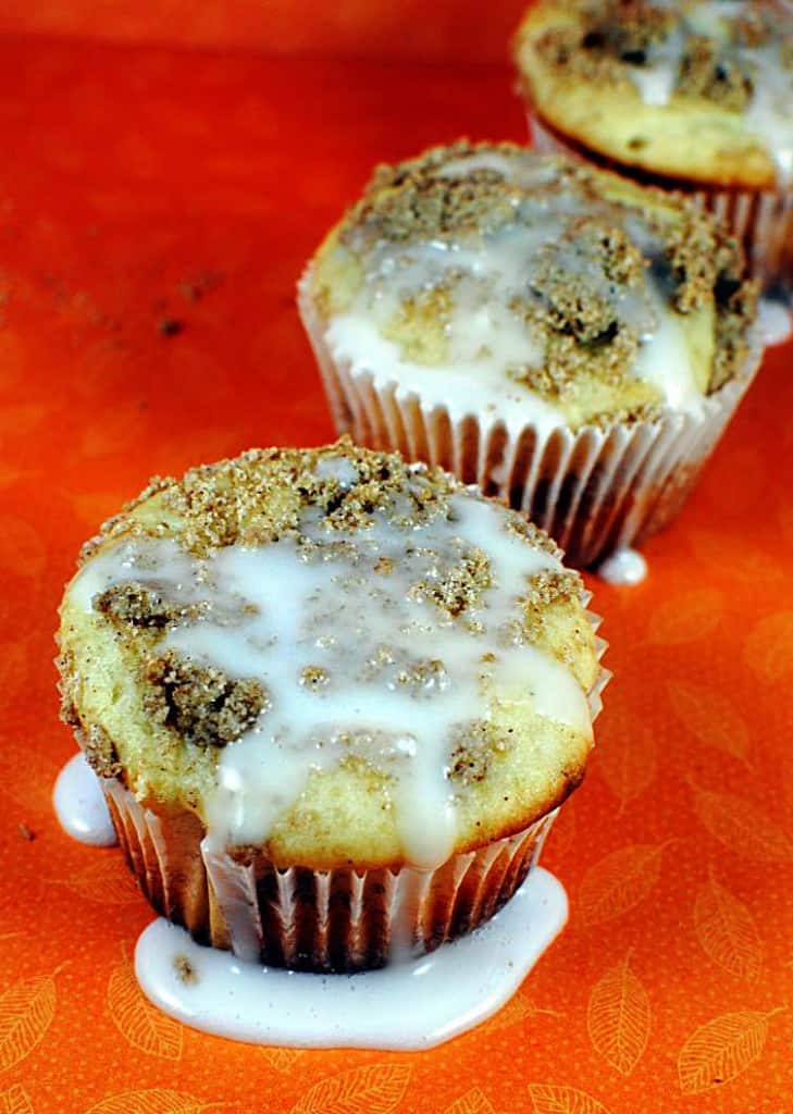 Coffee cake muffins are the best possible treat for a weekend morning. They're moist streusel coffee cake with a sweet glaze on top. | Recipe on PassTheSushi.com