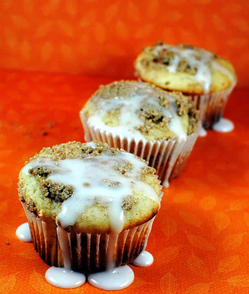 Coffee cake muffins are the best possible treat for a weekend morning. They're moist streusel coffee cake with a sweet glaze on top. | Recipe on PassTheSushi.com