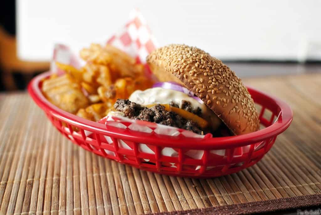 The "From Away" Burger in a red basket with curly fries | Kita Roberts PassTheSushi.com