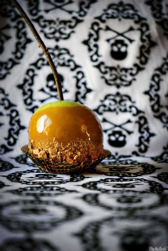 Butterfinger caramel apples will make you the favorite house for Trick or Treat! Tart Granny Smith apples coated with sweet, homemade Butterfinger caramel sauce. \\ PassTheSushi.com