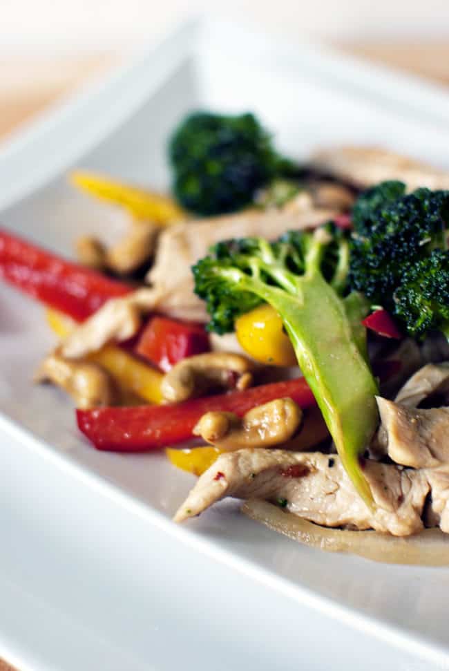Spicy cashew chicken is a super quick dinner recipe with chicken, broccoli, peppers, cashews, all covered in spicy Asian sauce. \\ PassTheSushi.com