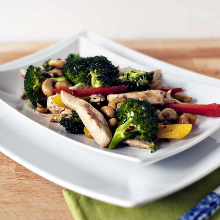 Spicy cashew chicken is a super quick dinner recipe with chicken, broccoli, peppers, cashews, all covered in spicy Asian sauce. \\ PassTheSushi.com