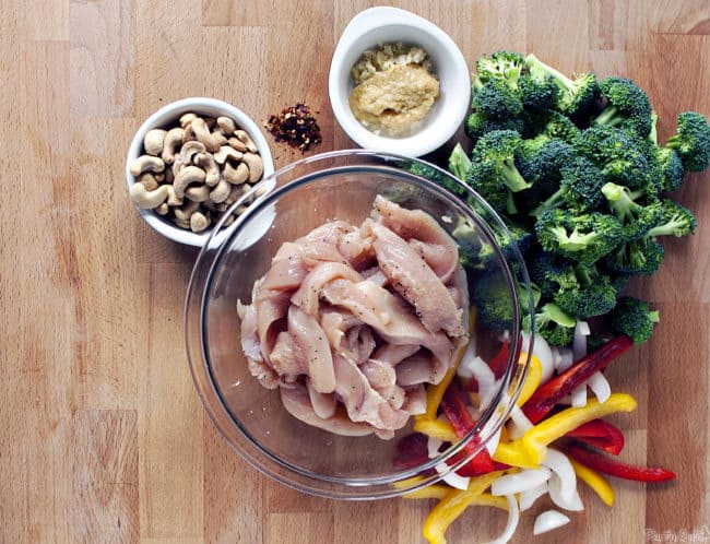 Spicy cashew chicken is a super quick dinner recipe with chicken, broccoli, peppers, cashews, all covered in spicy Asian sauce. \\ PassTheSushi.com