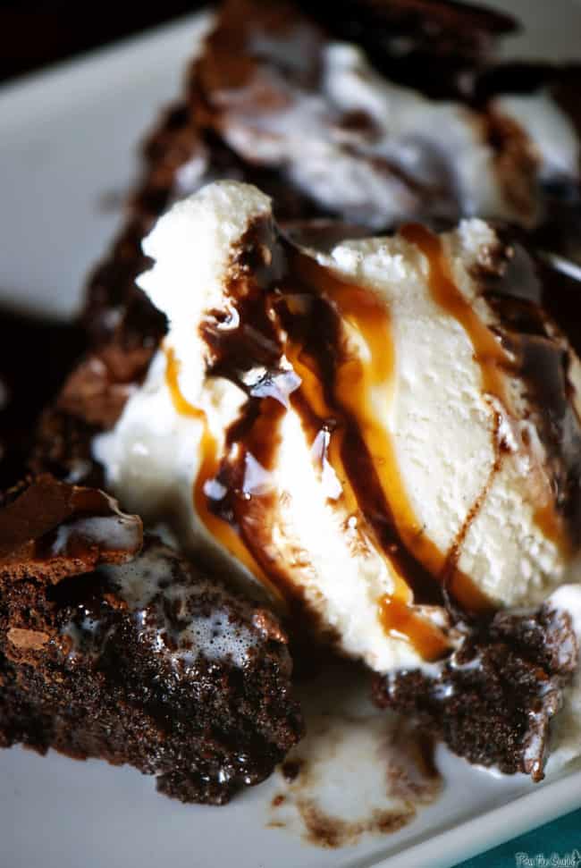 Skillet brownies topped with vanilla ice cream, then drizzled with caramel and chocolate sauce take fudgy brownies to the next level of goodness. They become a skillet brownies sundae! | PassTheSushi.com