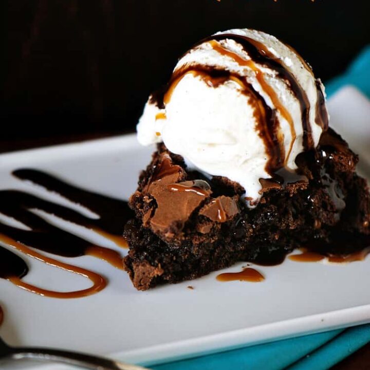 Skillet brownies ﻿topped with vanilla ice cream, then drizzled with caramel and chocolate sauce take fudgy brownies to the next level of goodness. They become a skillet brownies sundae! | PassTheSushi.com