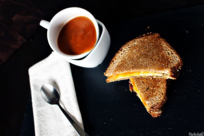 Slow cooker tomato soup is creamy and comforting, and pairs exceptionally well next to a grilled cheese sandwich. This easy slow cooker recipe is a must make! \\ PassTheSushi.com