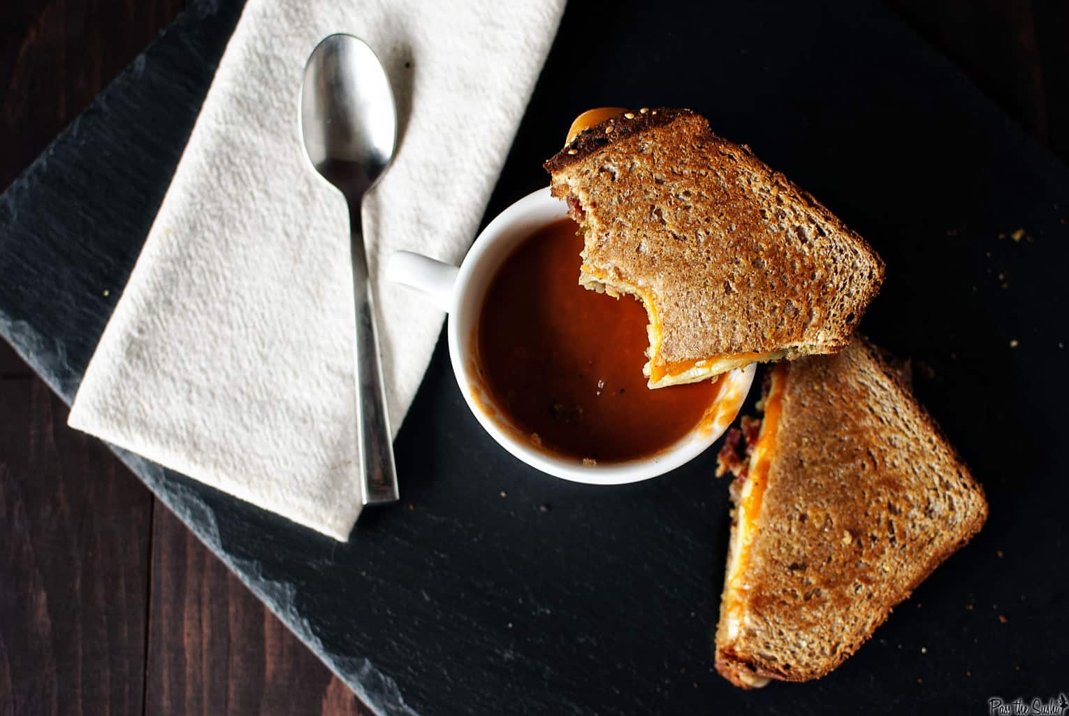 Slow cooker tomato soup is creamy and comforting, and pairs exceptionally well next to a grilled cheese sandwich. This easy slow cooker recipe is a must make! \\ PassTheSushi.com