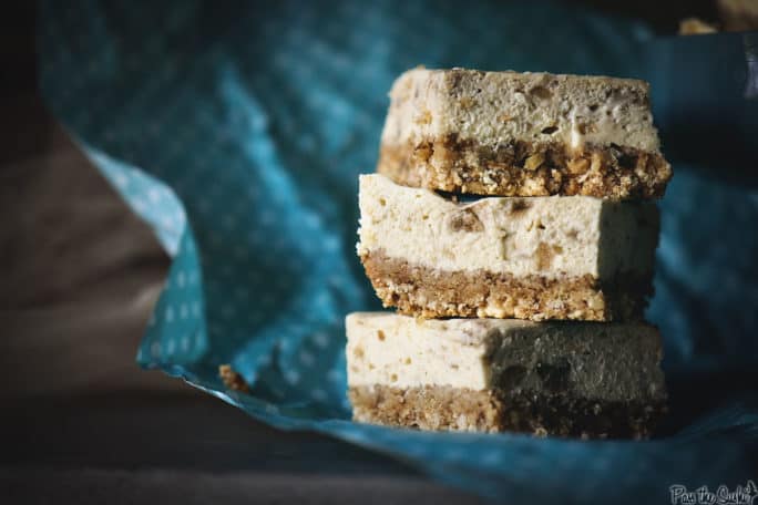 Stacked Bananas Foster Cheesecake Bars on a blue platter