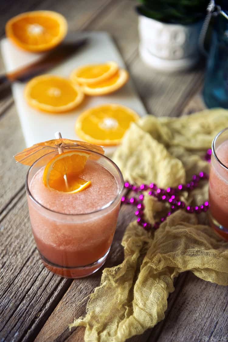 Pink rum runner with orange slice as garnish.