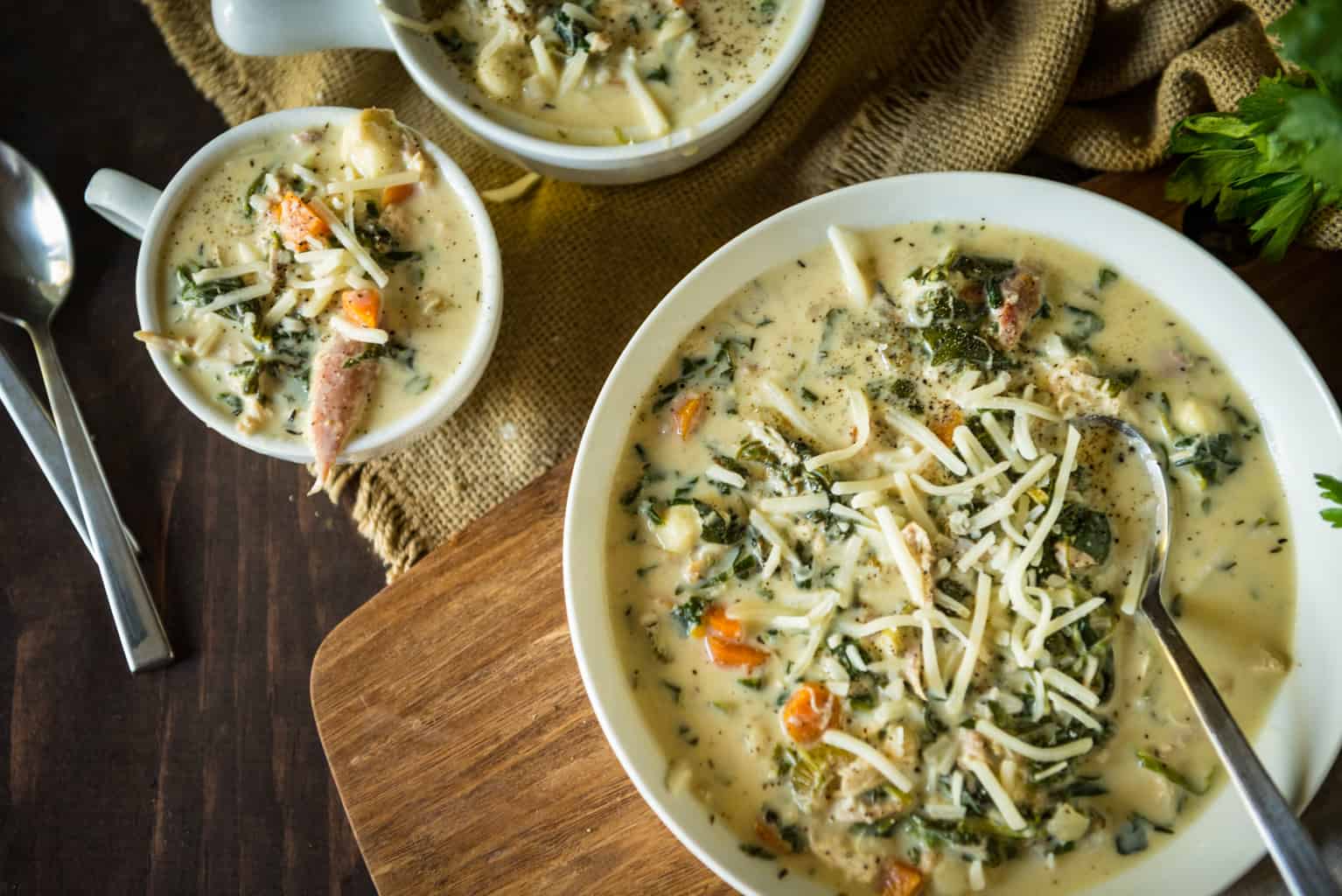 Creamy soup in crispy white bowls garnished with parmesan cheese. 