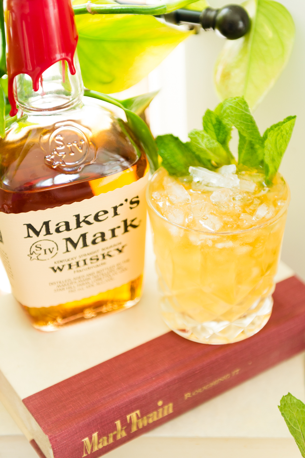 Close up of a mint julep and Makers Mark bottle. 