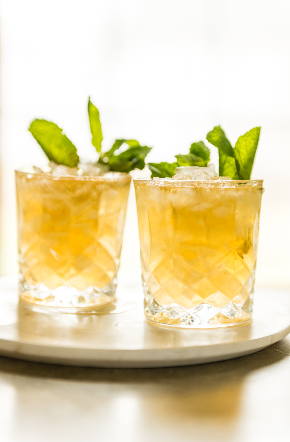 Backlight crystal highball glasses filled with ice and this cocktail. 