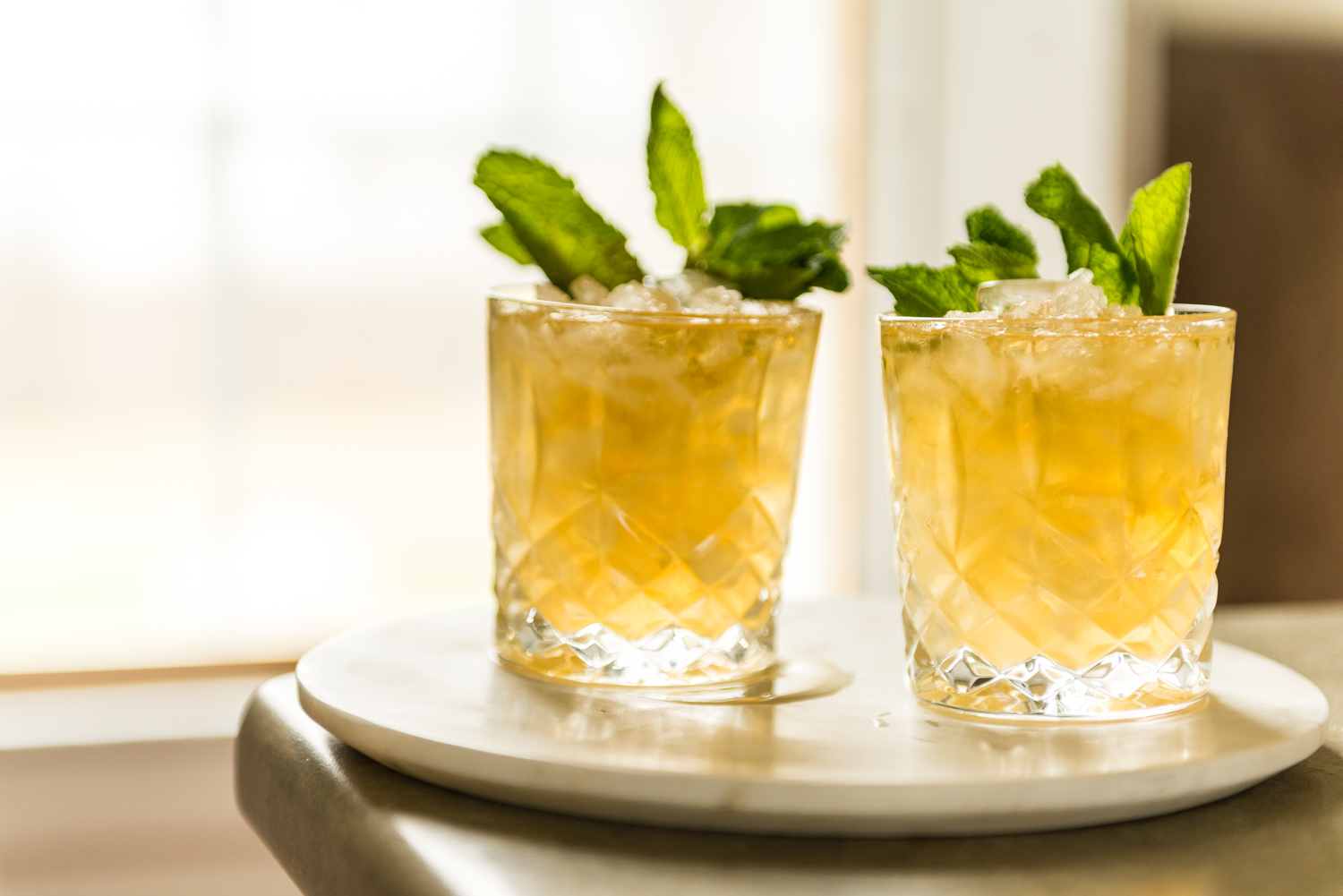 Backlight mint julep cocktails with crushed ice and mint. 