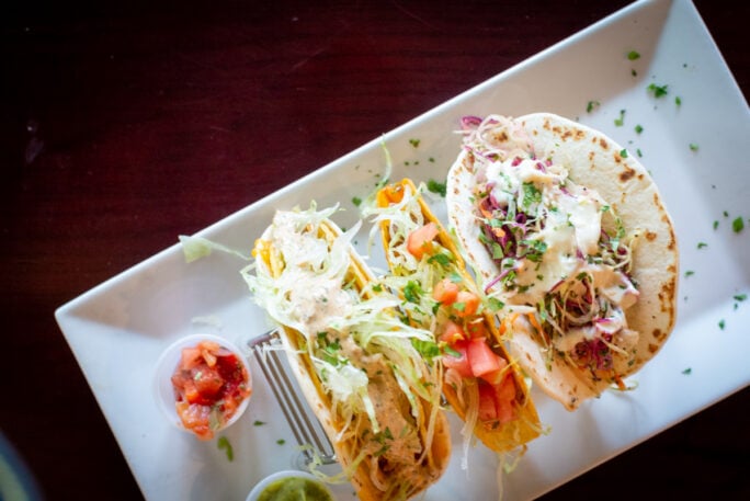 Taco Tuesday - three different tacos on a white plate at Mauras kitchen 