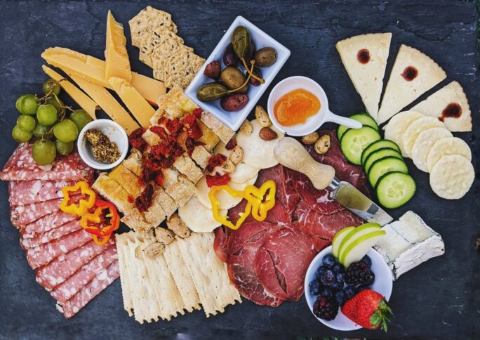 A perfect charcuterie board! with cheese, capers and meats