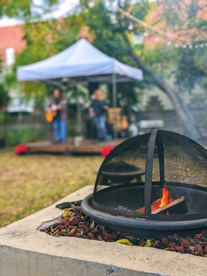 the sitting space at Casa De Vino 57 with fire pit and small stage for live music is heaven