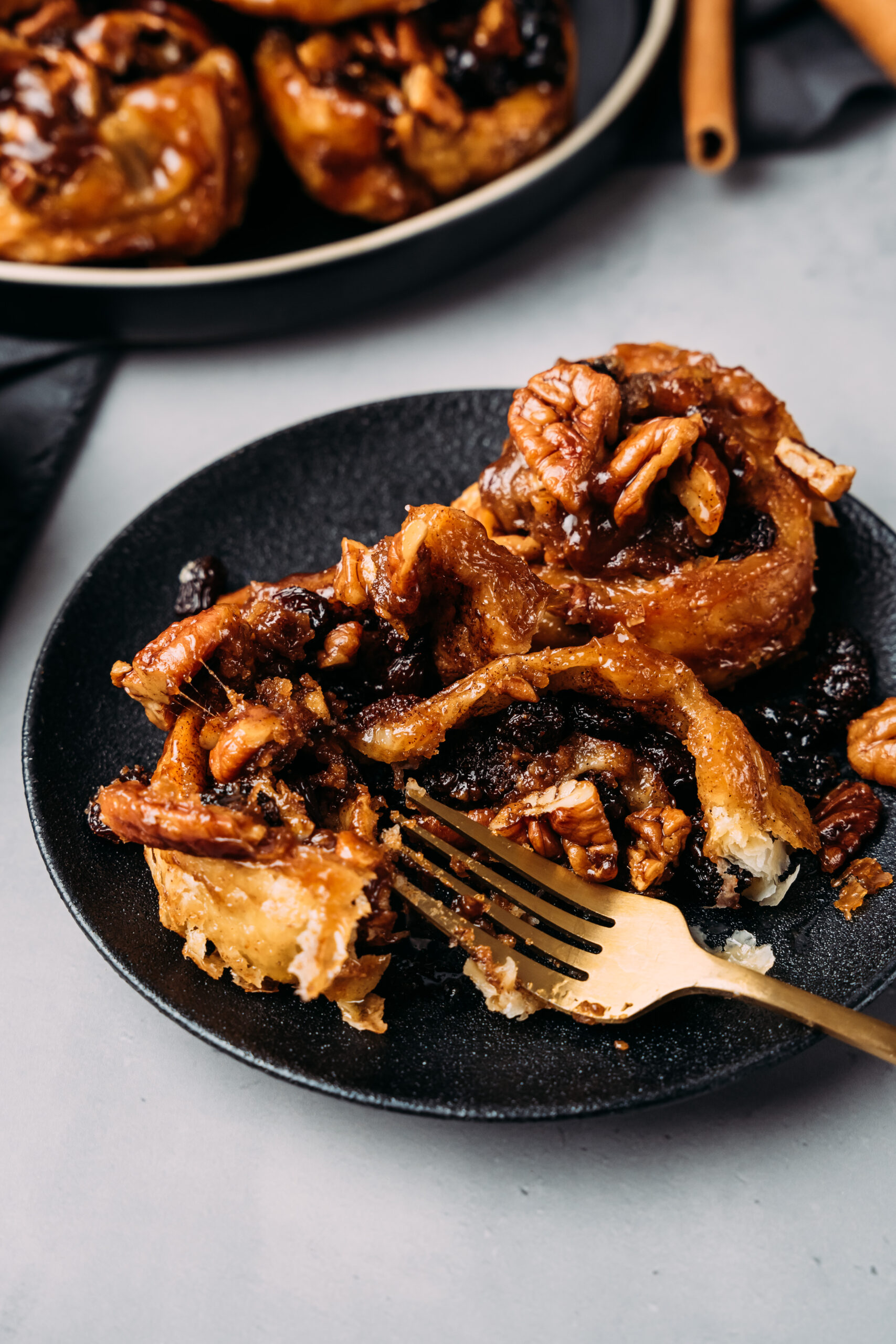 plate of sticky buns with a fork digging in