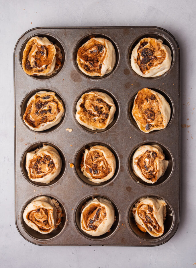 muffin pan with semi-cooked buns