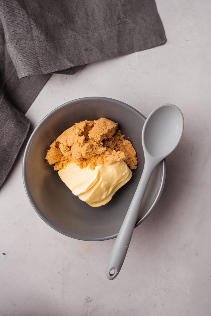 placing butter and sugar in a bowl