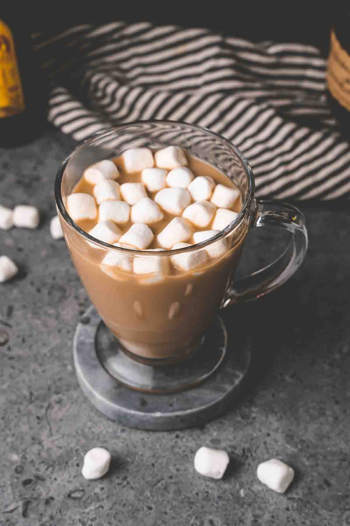 Marshmallows atop a coffee cocktail in a glass mug. 