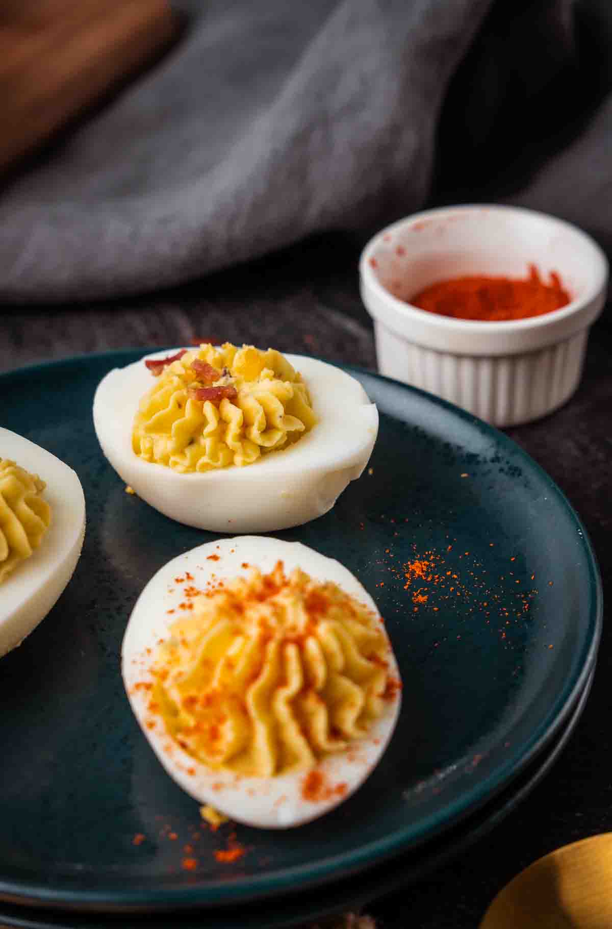 devilled eggs on a plate dusted with paprika