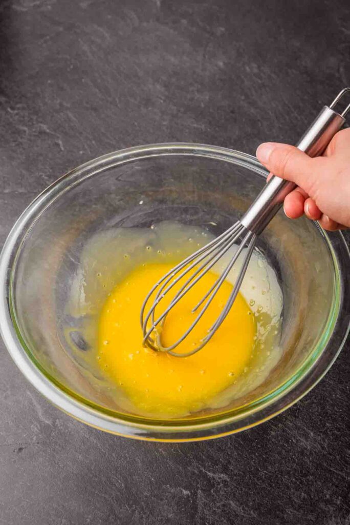 whisked yolks in glass bowl