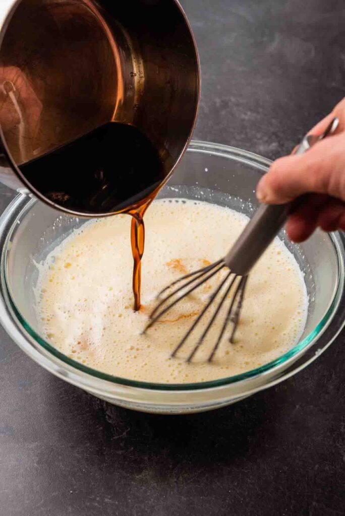 mixing wet ingredients in a glass bowl