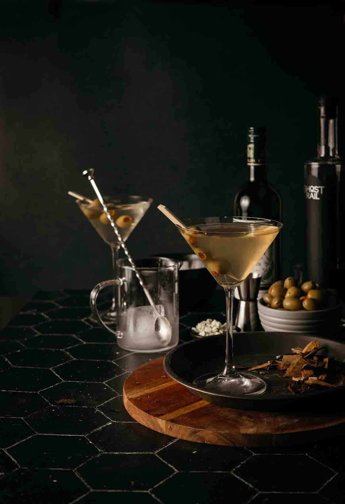 Dirty martinis garnished with olives to serve. 