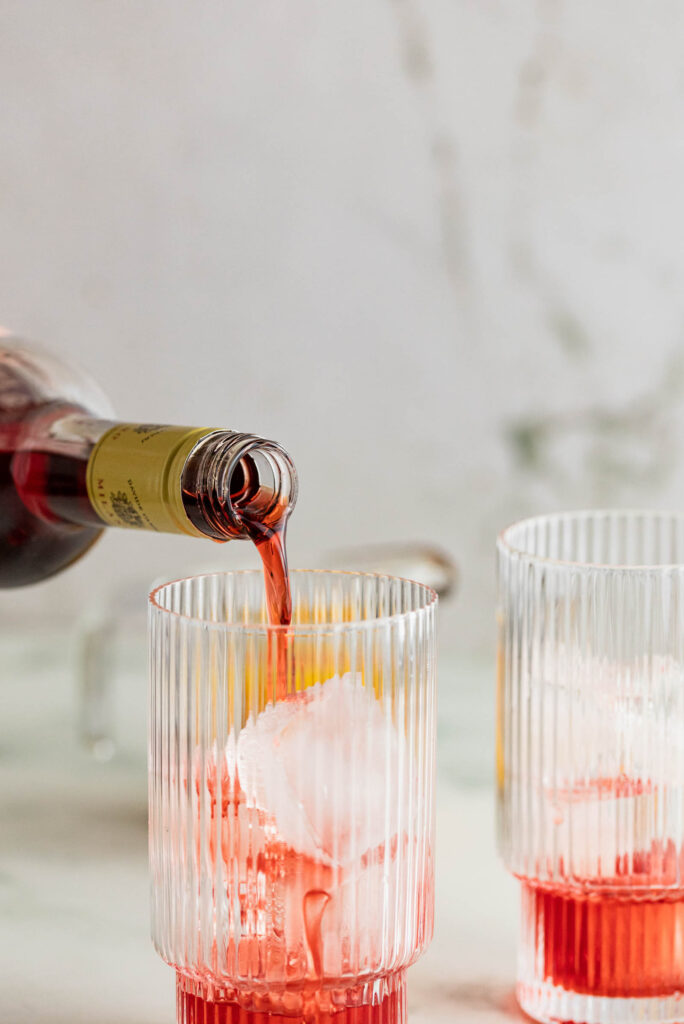 Campari being poured into a galss.