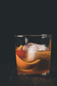 Side shot of a highball glass holding an old fashioned.