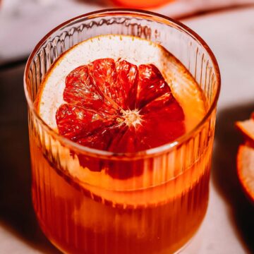 Overhead shot of a grapefruit garnish in a cocktail glass.