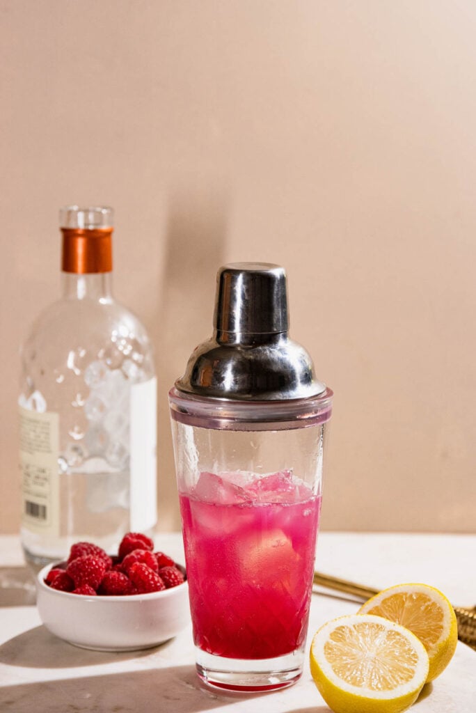 Cocktail shaker with lid on ready to be mixed.