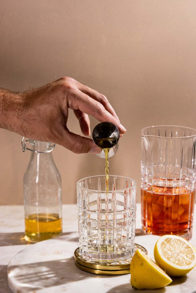 Absinthe being poured into a rocks glass.