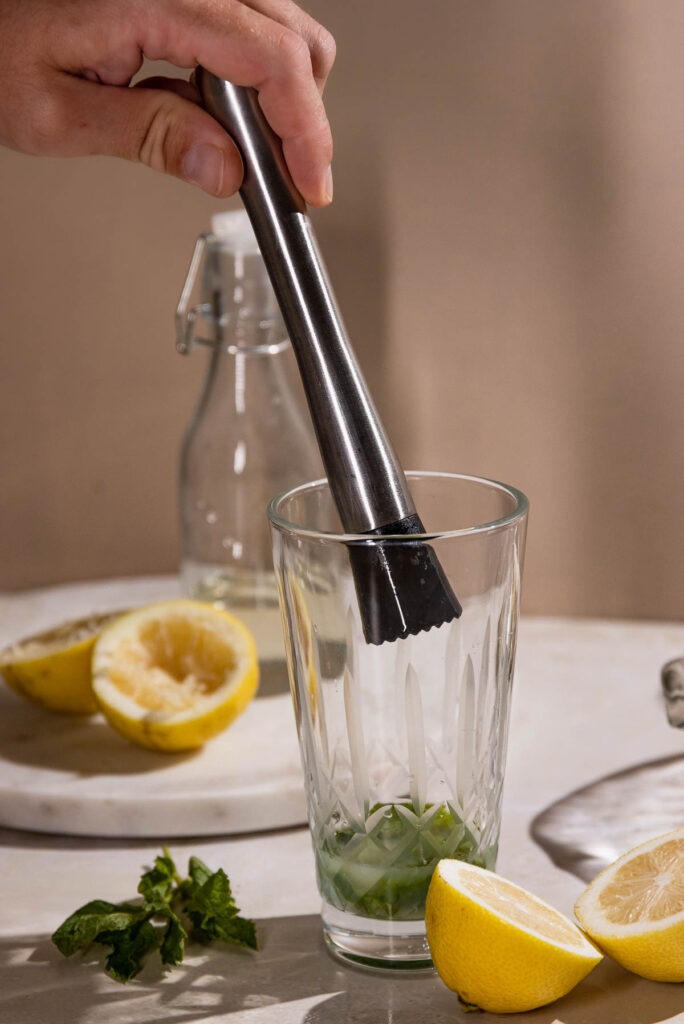 Muddler in a cocktail shaker for the mint. 