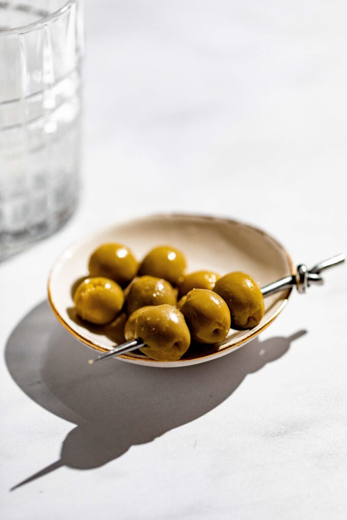 Olives on a cocktail pick.