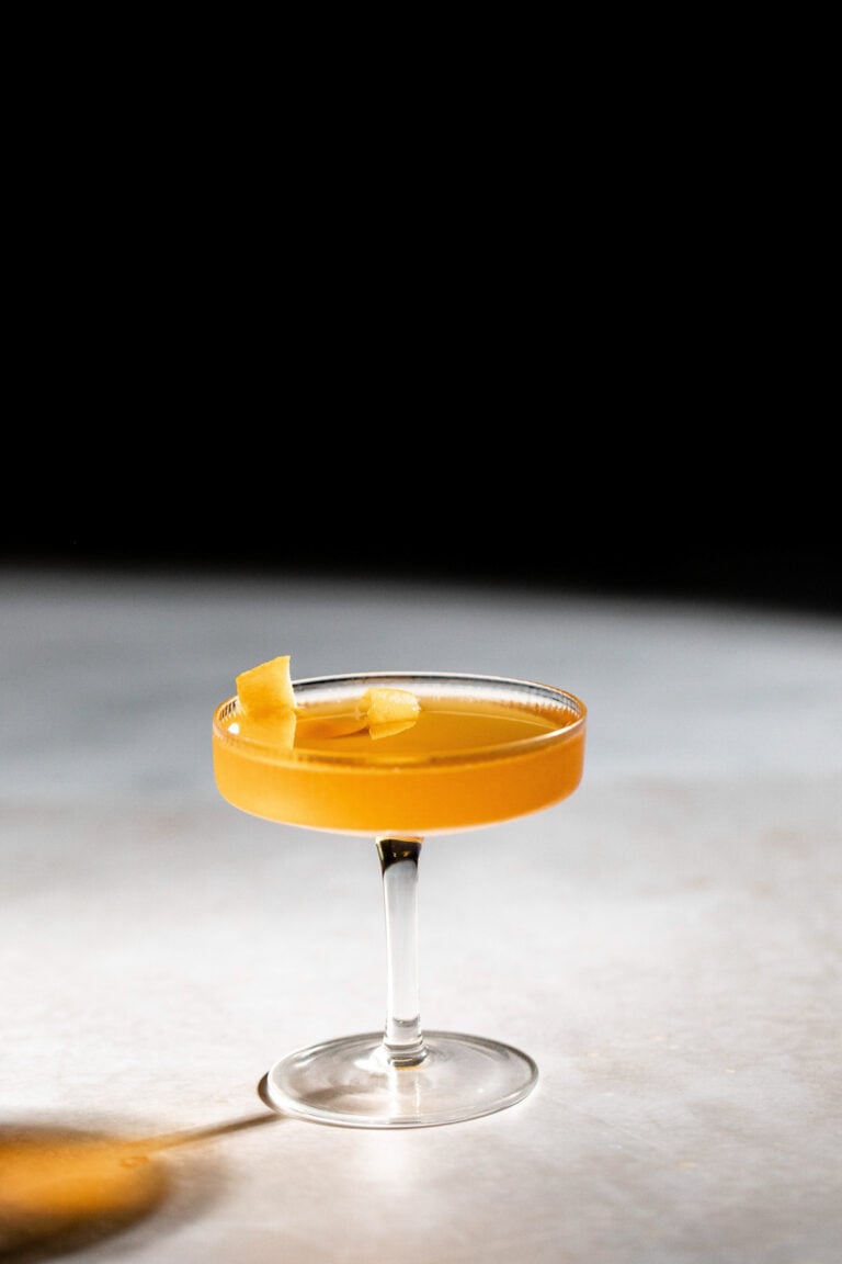 A single cocktail glass filled to the rim with a sidecar.