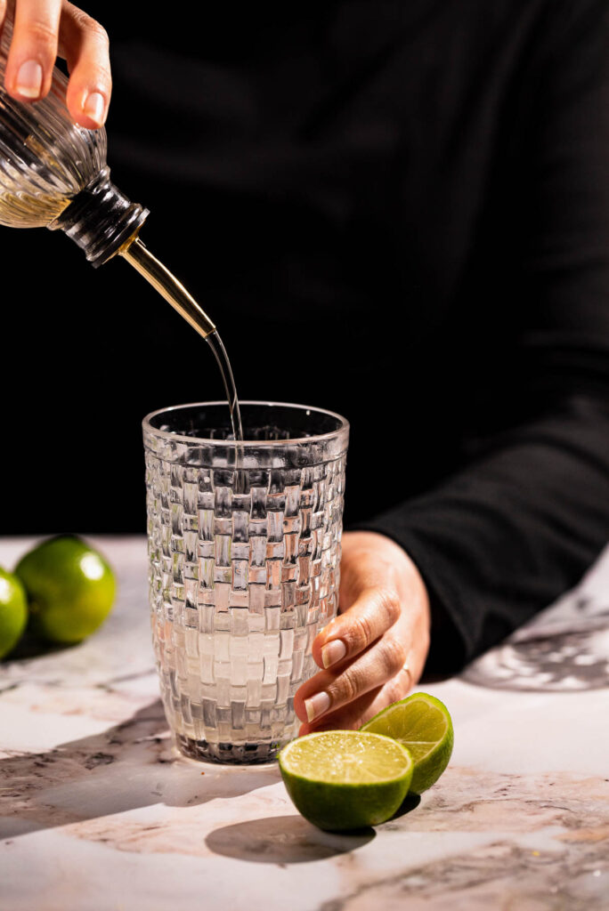 Agave being poured into the cocktail glass.